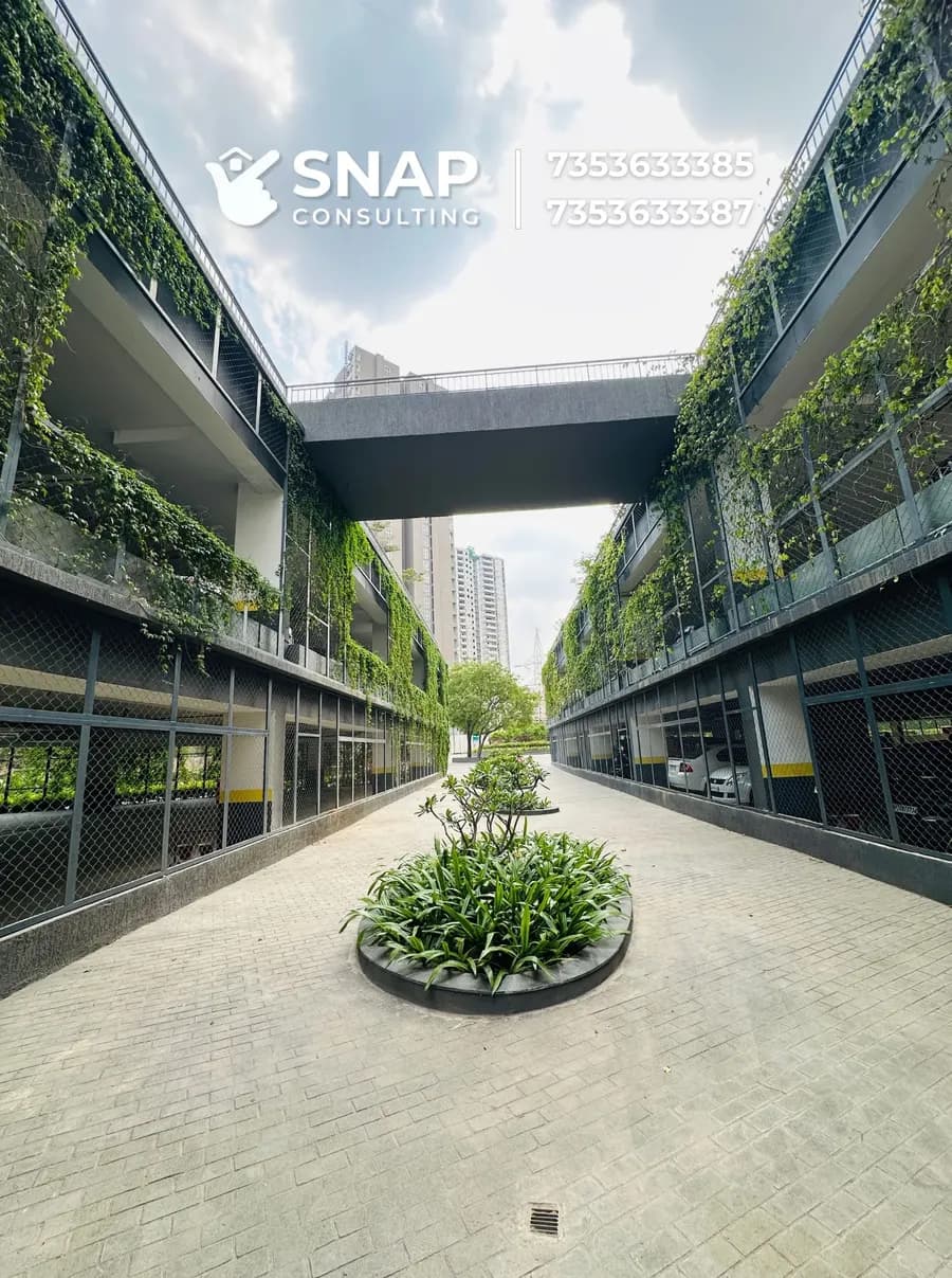 Covered walkway lined with vertical gardens at Assetz Marq