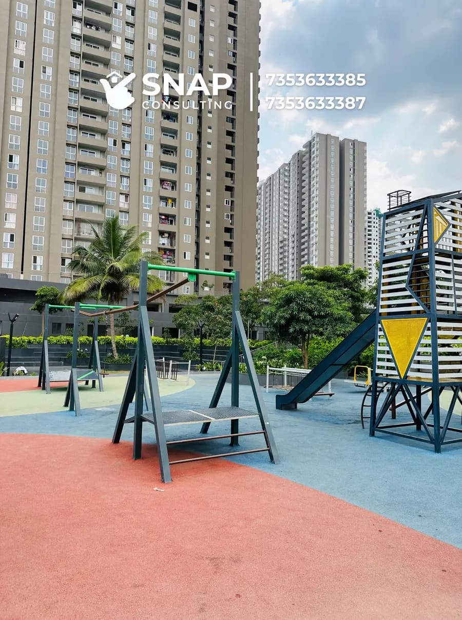 Children's play area with swings and slide at Assetz Marq