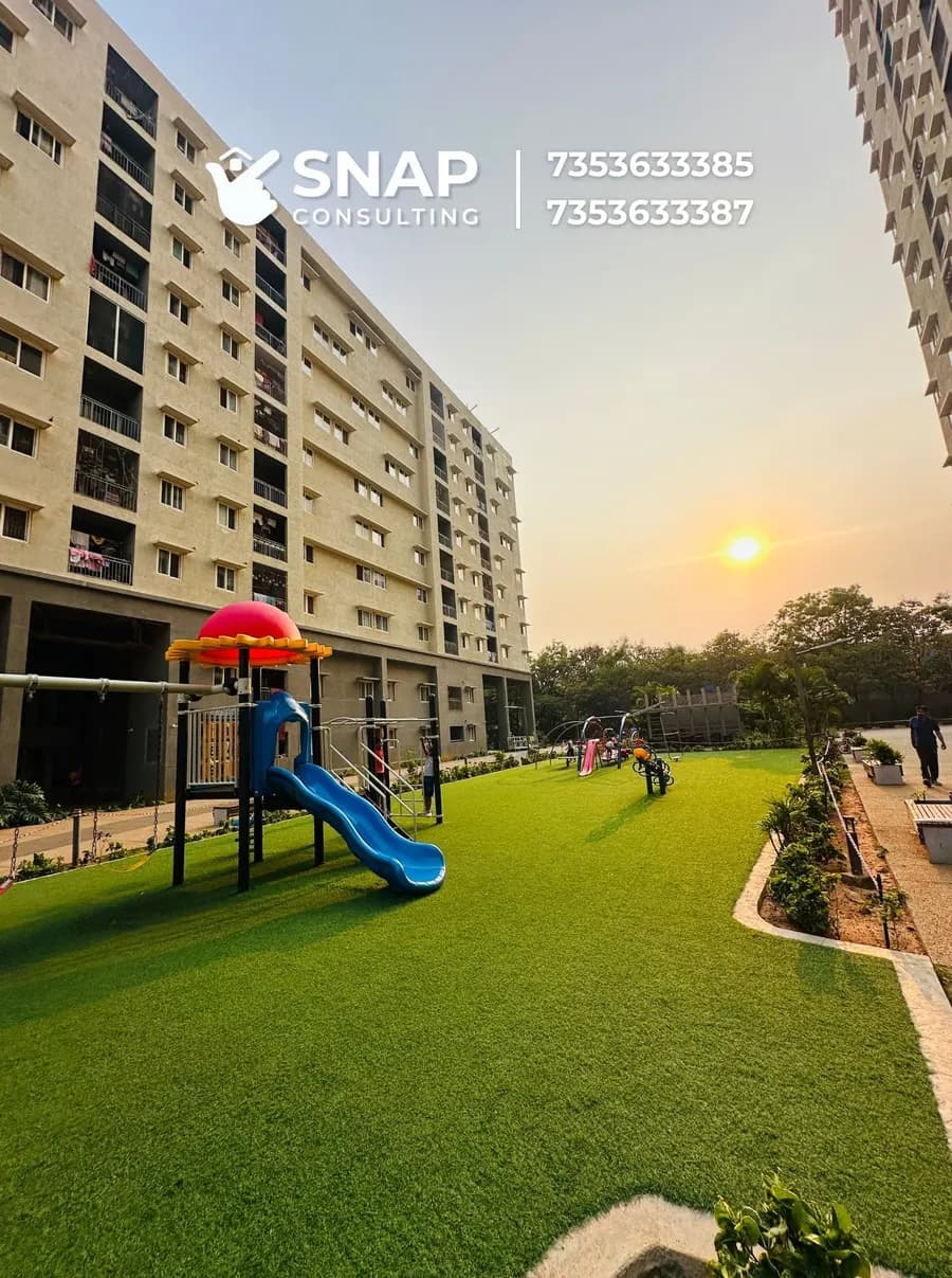 Lawn and kids' play equipment beside the towers at Assetz Marq