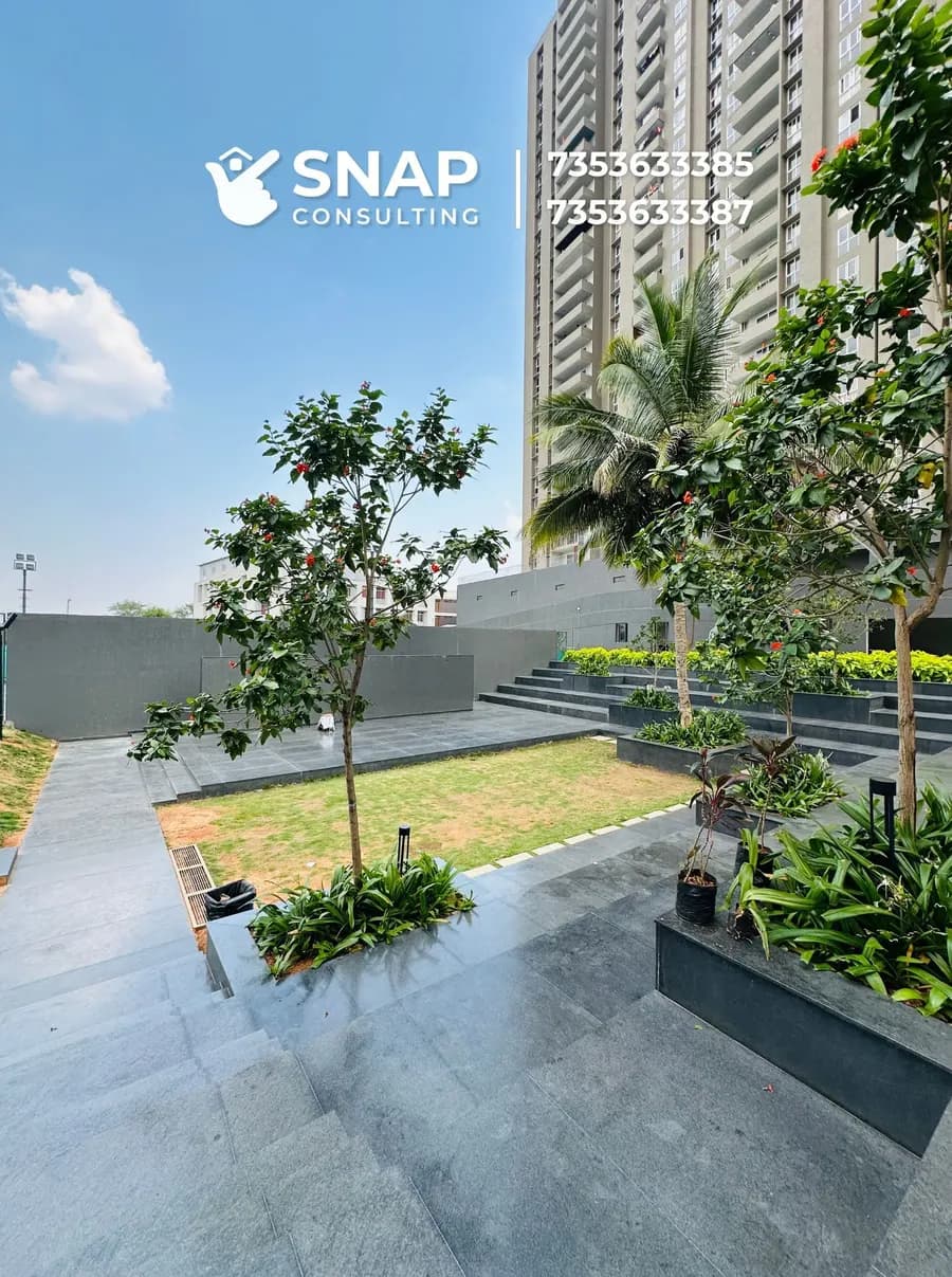 Paved courtyard with trees and planters at Assetz Marq