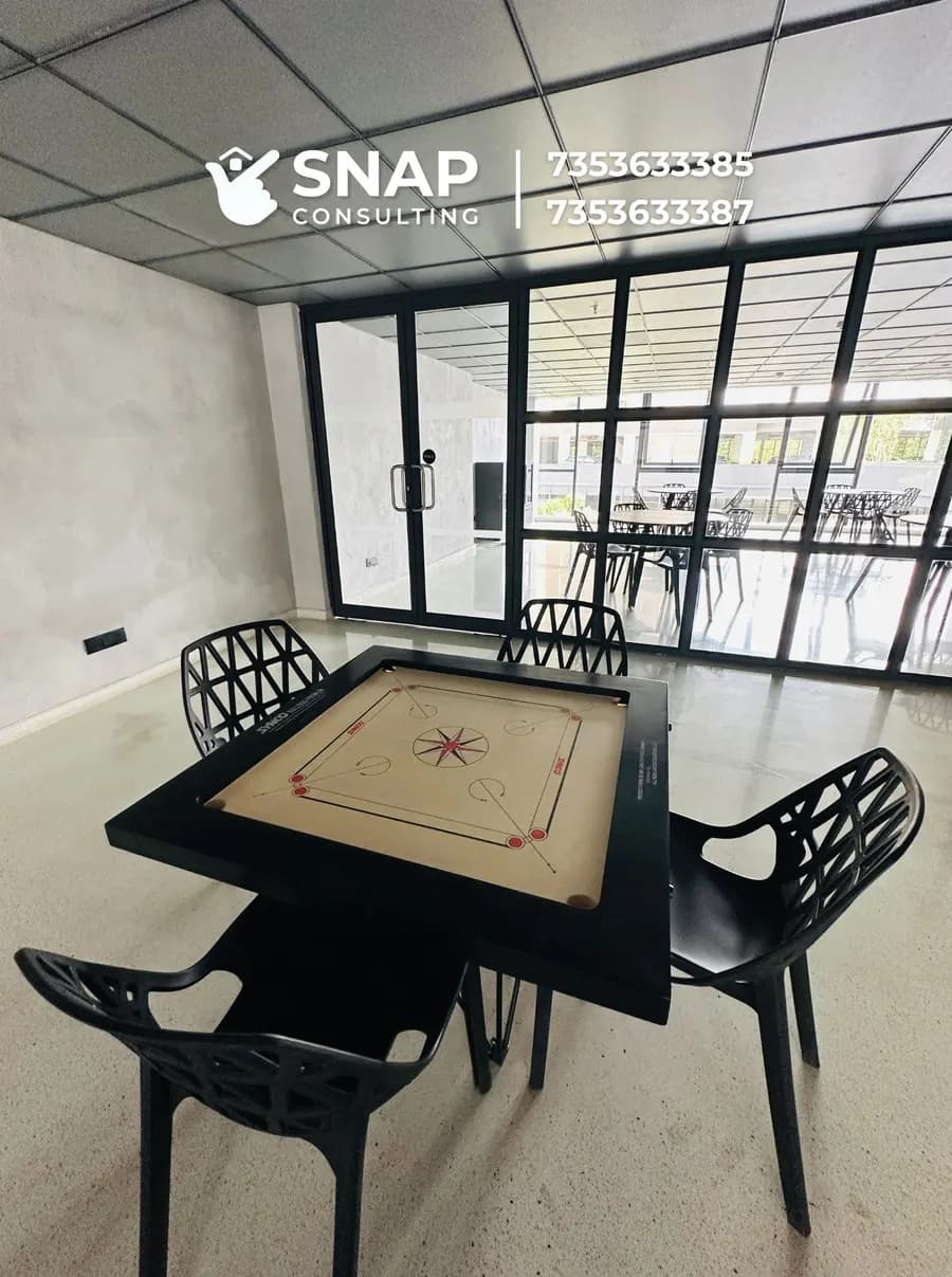 Cards room with a carrom board at Assetz Marq